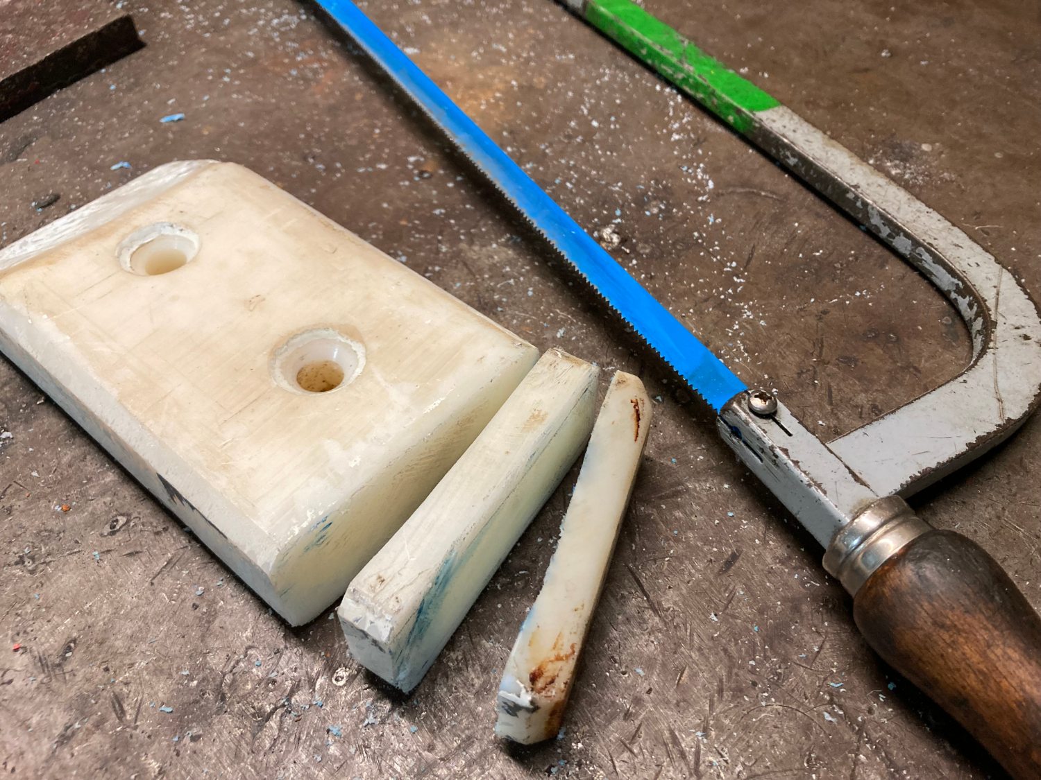 A large block of polyamide is sawn into small pieces.
